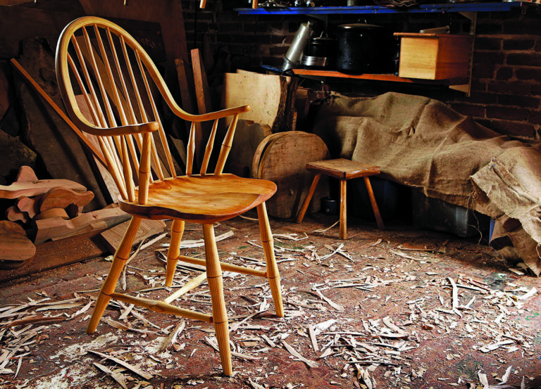 Wooden chair in a workshop with shavings.