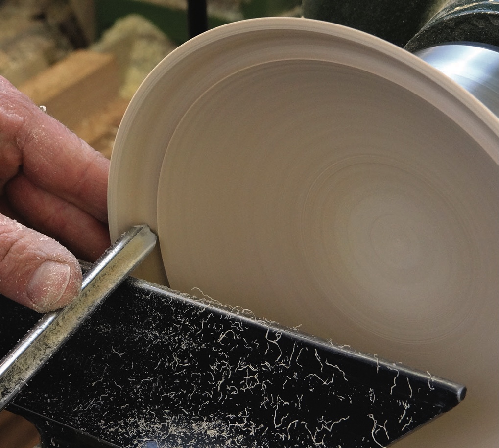 Woodturning on a lathe with hand tool