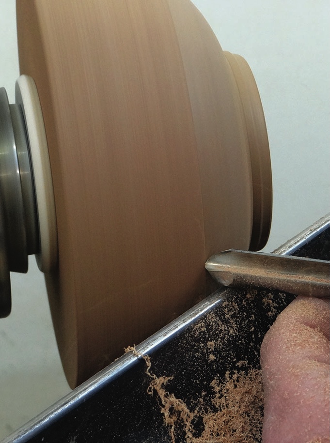 Wood being turned on a lathe by craftsman.