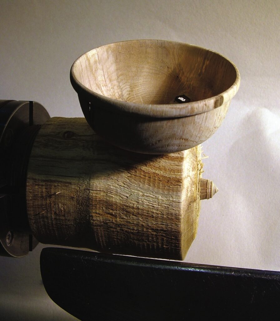 Wooden bowl being crafted on lathe machine