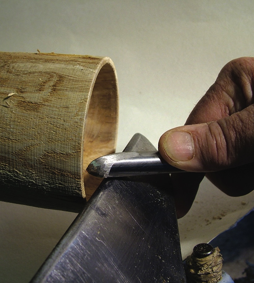 Woodturning with chisel on lathe