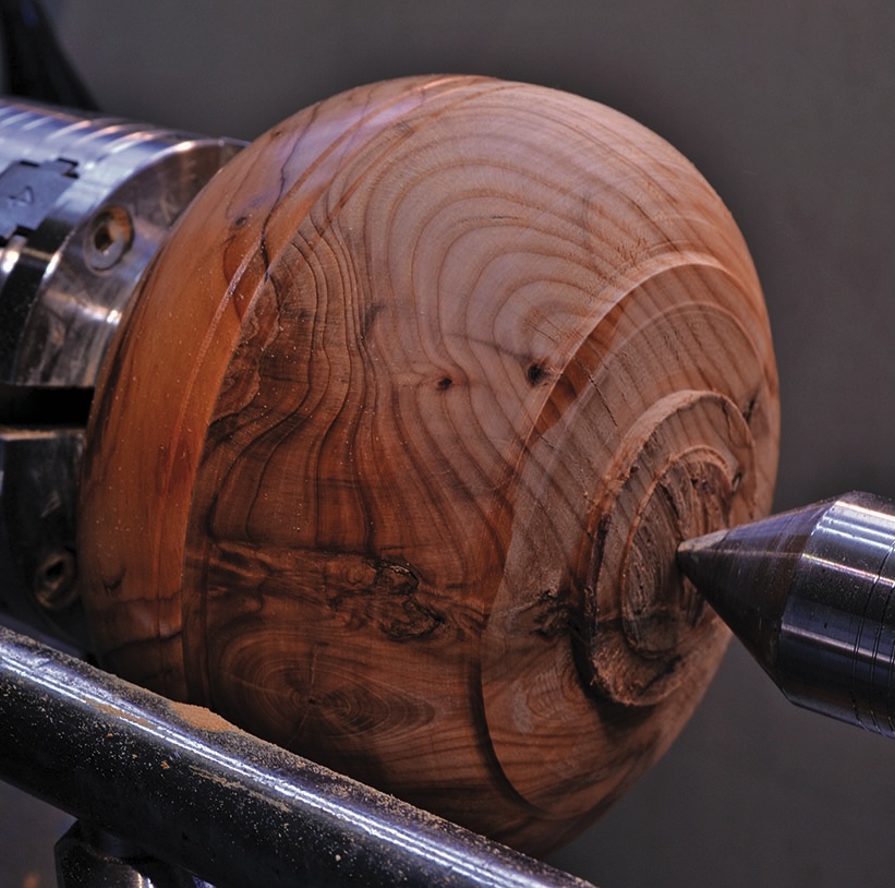 Woodturning a wooden sphere on a lathe