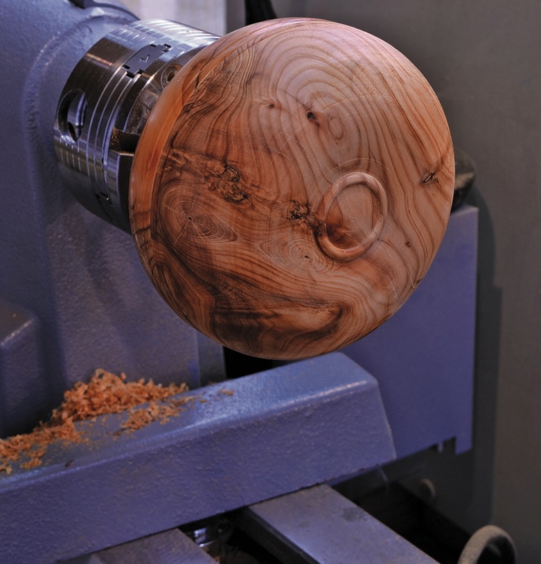Wooden bowl crafted on a lathe machine.