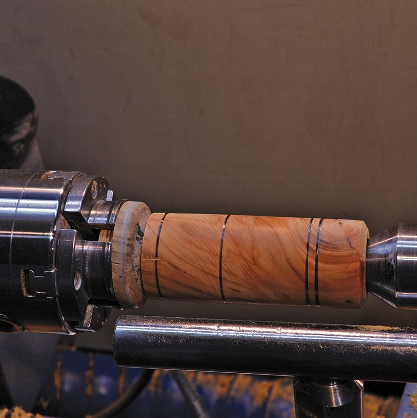 Woodturning on lathe machine with wood piece.
