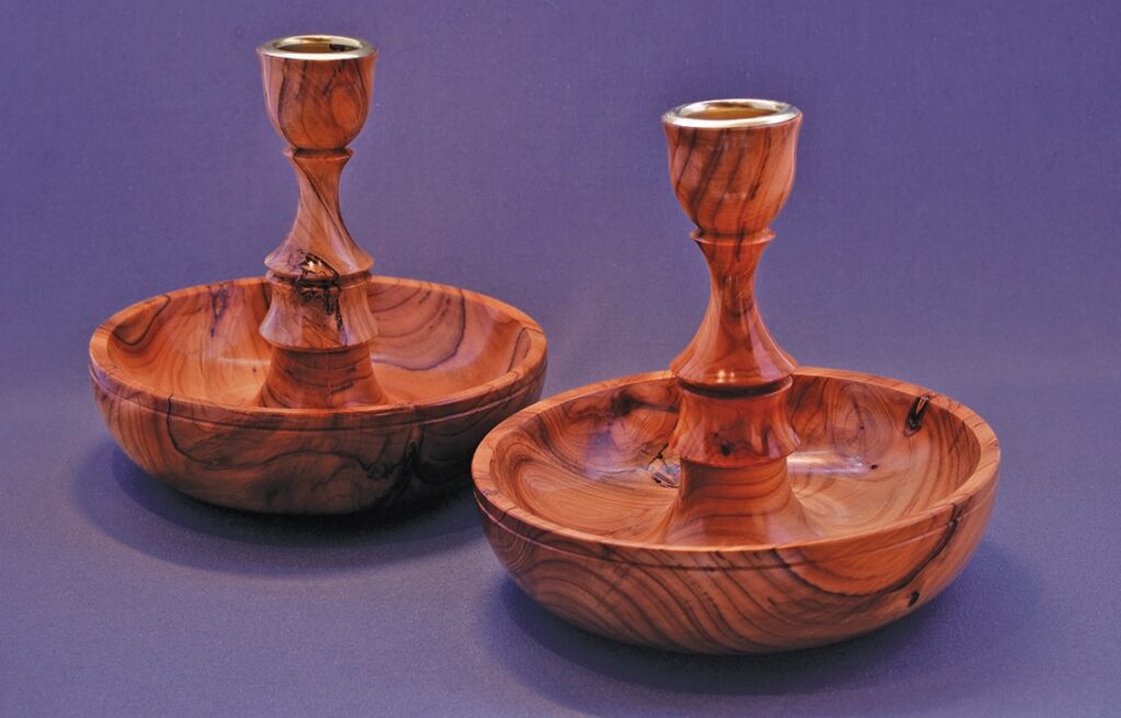 Pair of handcrafted wooden candlesticks on display