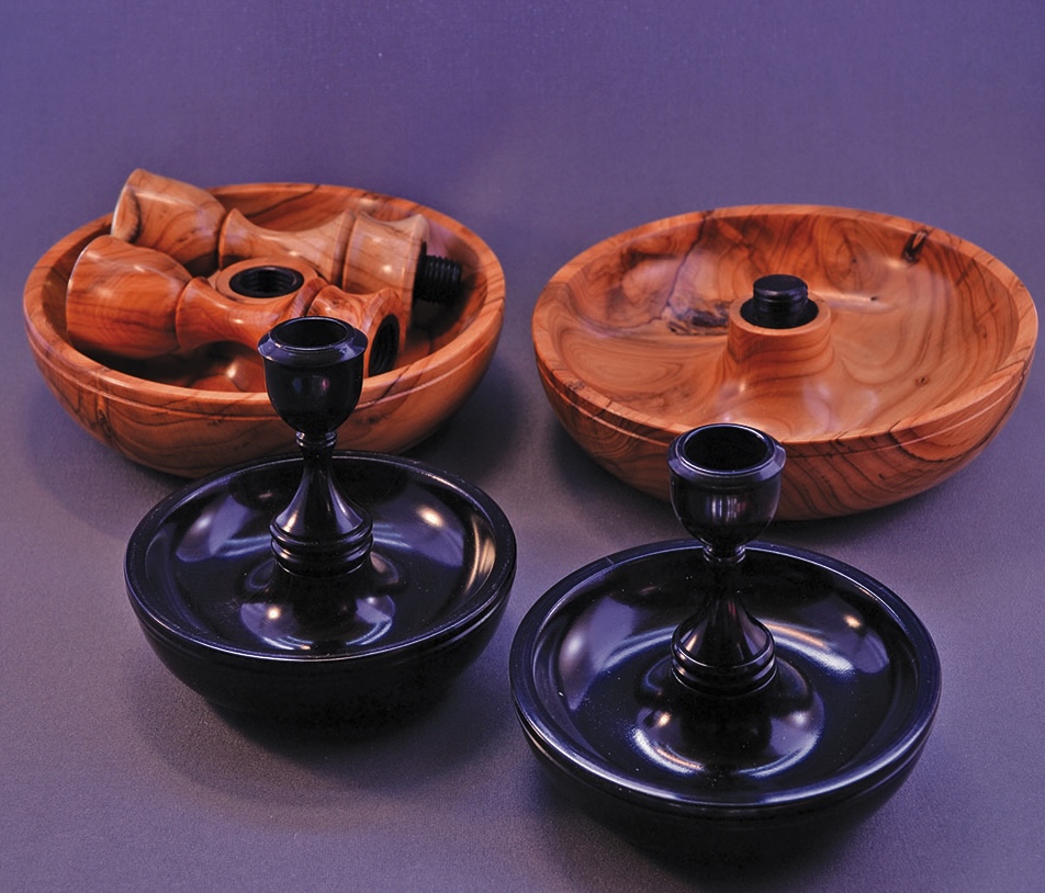 Wooden bowls and small candlestick holders display.