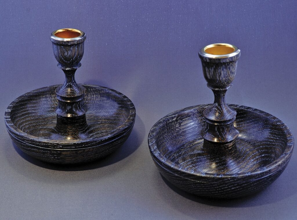 Pair of decorative wooden candlesticks on display