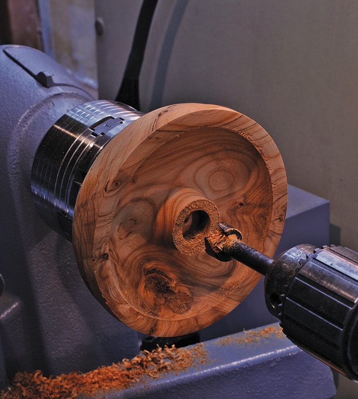 Wood being lathed on a workshop machine.