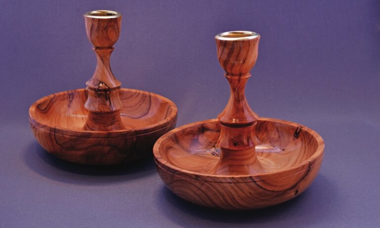 Two wooden candle holders with polished finish.