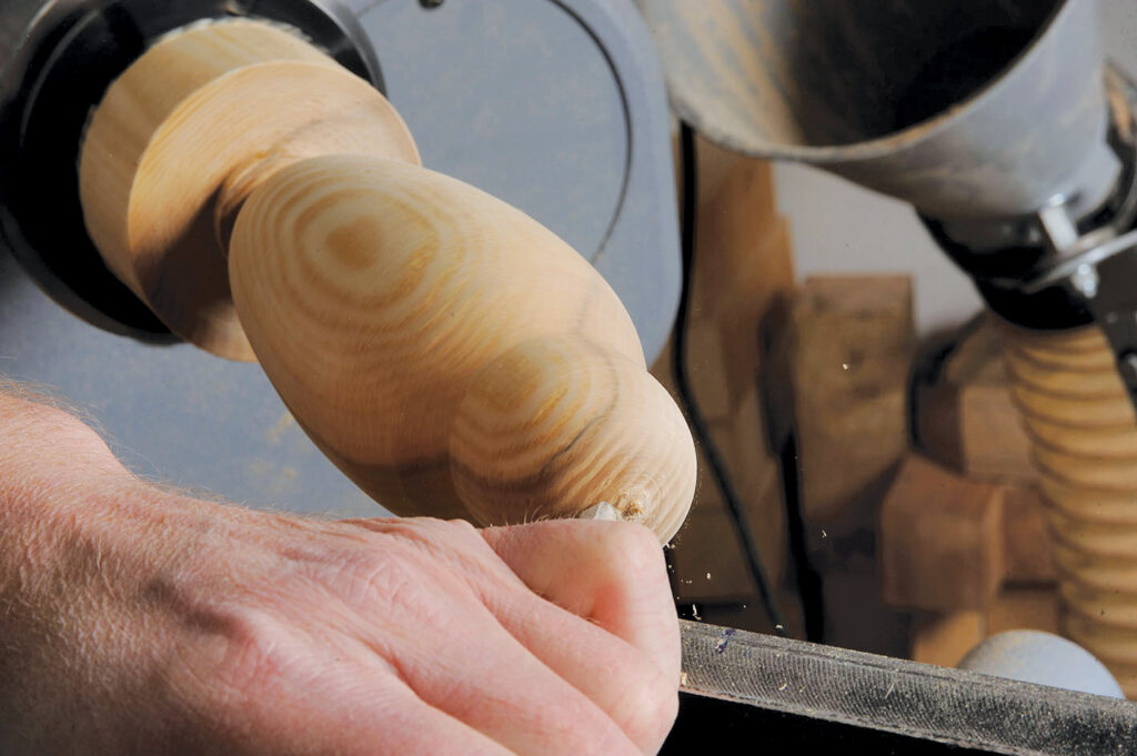 Hand carving wood on lathe machine