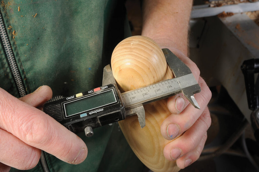 Measuring wooden object with digital caliper