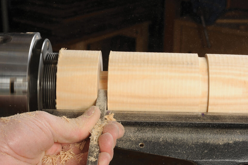 Wood being shaped on a lathe machine.