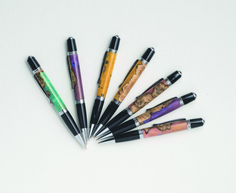 Colourful ballpoint pens on white background