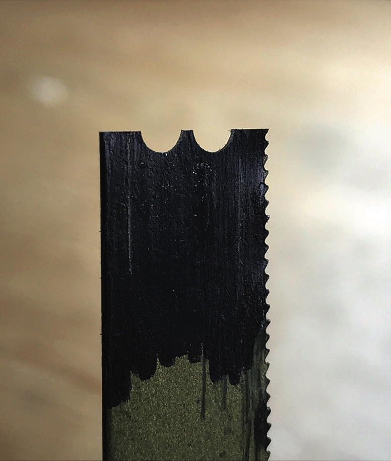 Close-up of saw blade with uneven edges.