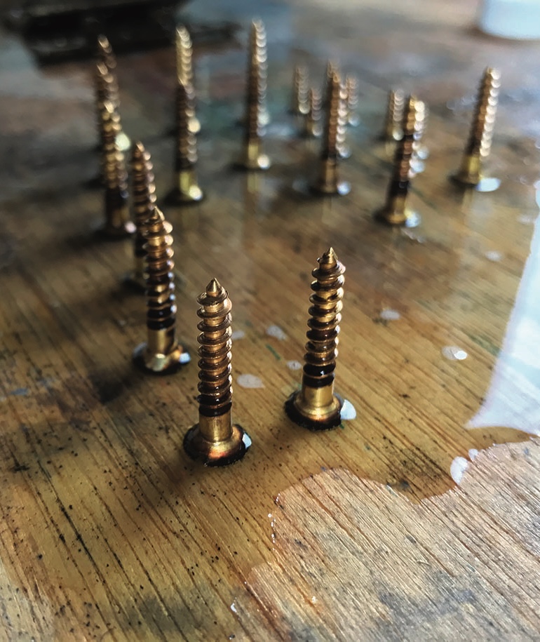 Wooden surface with vertical brass screws