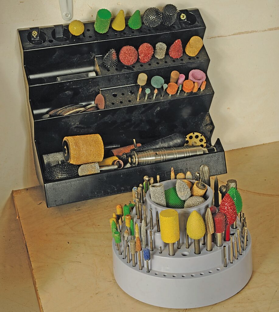 Assorted rotary tool attachments on holder tray.