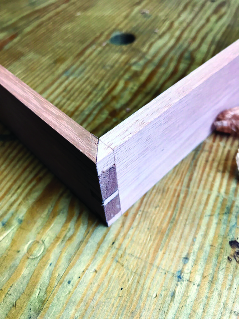 Close-up of wood dovetail joint on table