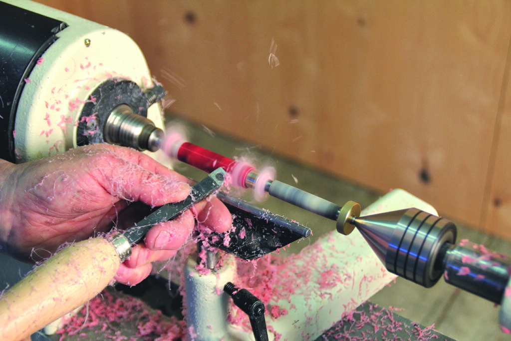 Turning wood on a lathe, shavings everywhere.