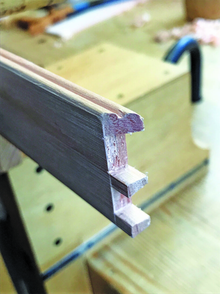Close-up of wooden dovetail joint in workshop.