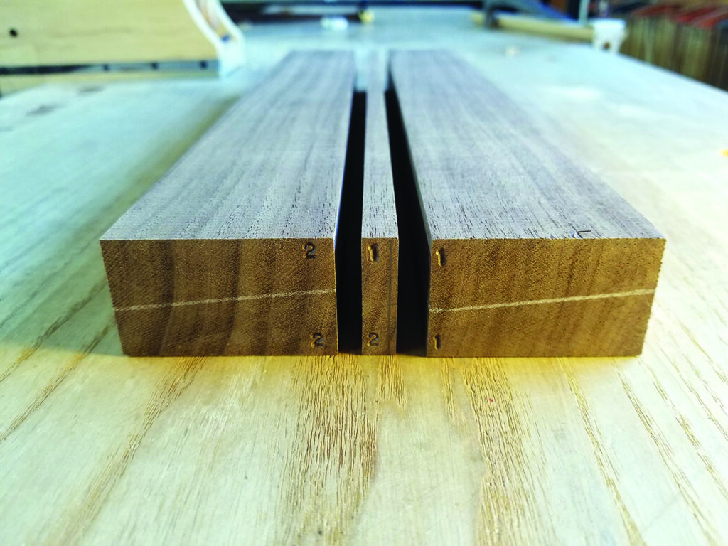 Close-up of two wooden beams on workbench.
