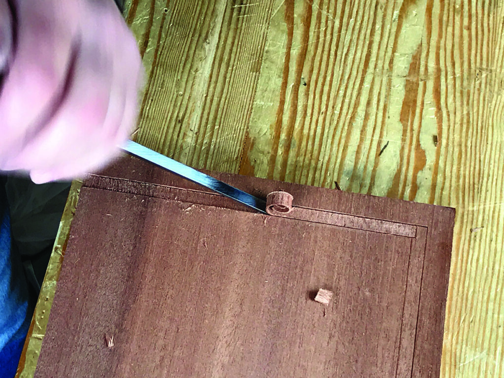 Carving wood with a sharp chisel tool