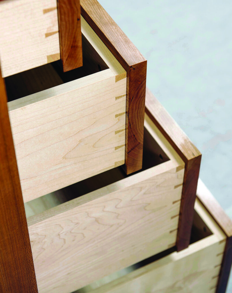 Wooden dovetail drawers partially open.