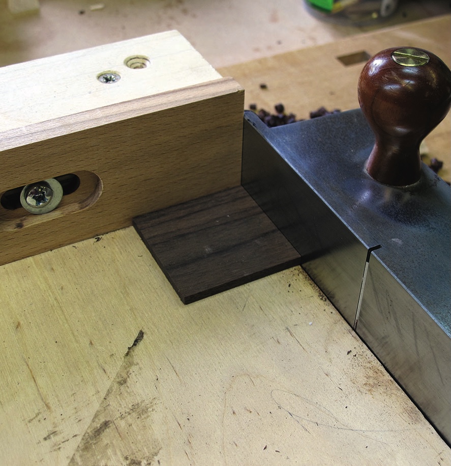 Woodworking setup with plane and guide block.