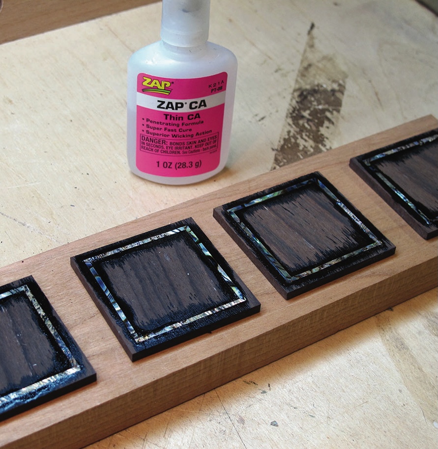 Wooden inlays with glue bottle on table