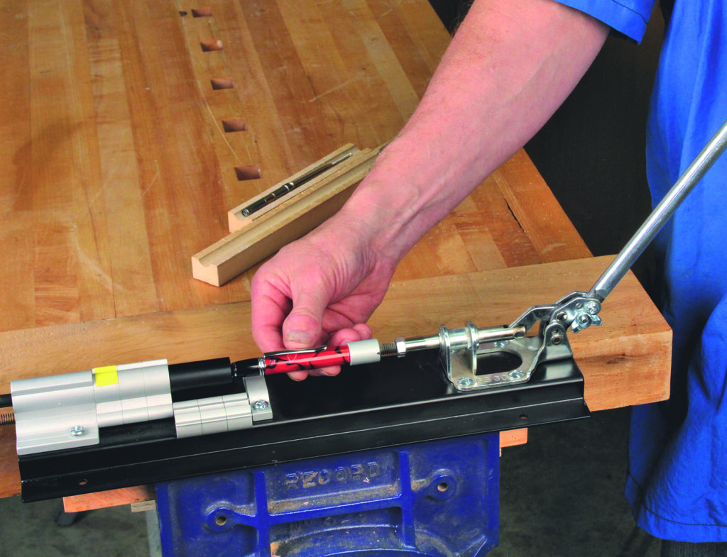 Person demonstrating woodworking tool on a workbench.