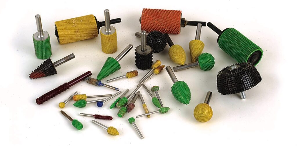 Assorted coloured rotary burrs for woodworking.