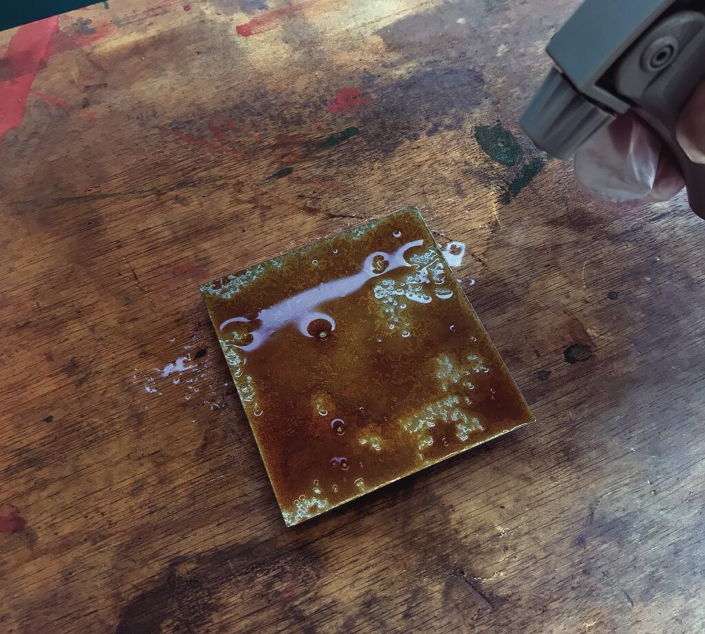 Applying patina to metal sheet with spray bottle