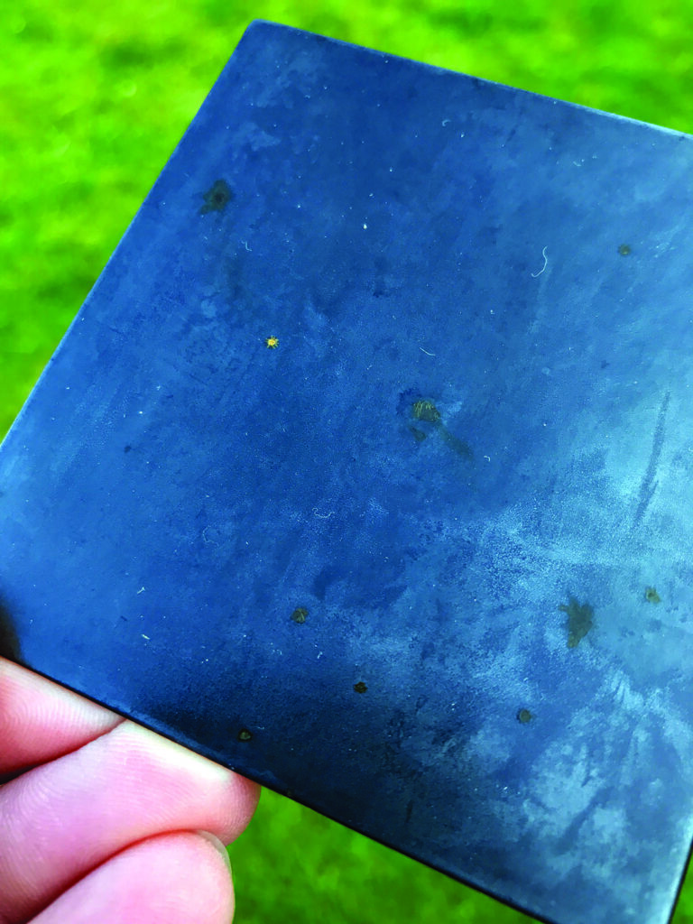 Close-up of blue square metal sheet.
