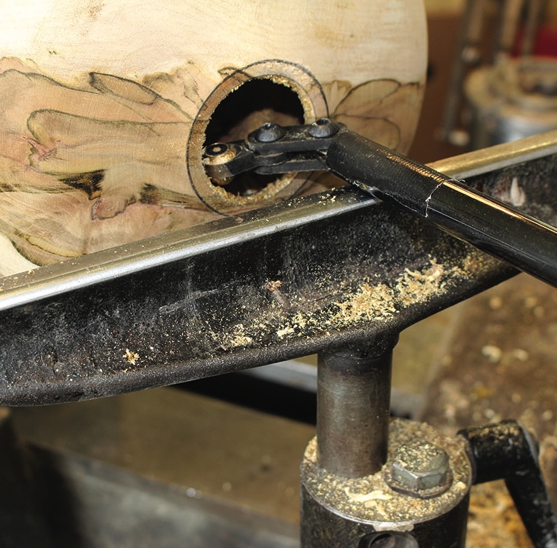 Wood lathe machine carving a wooden bowl.