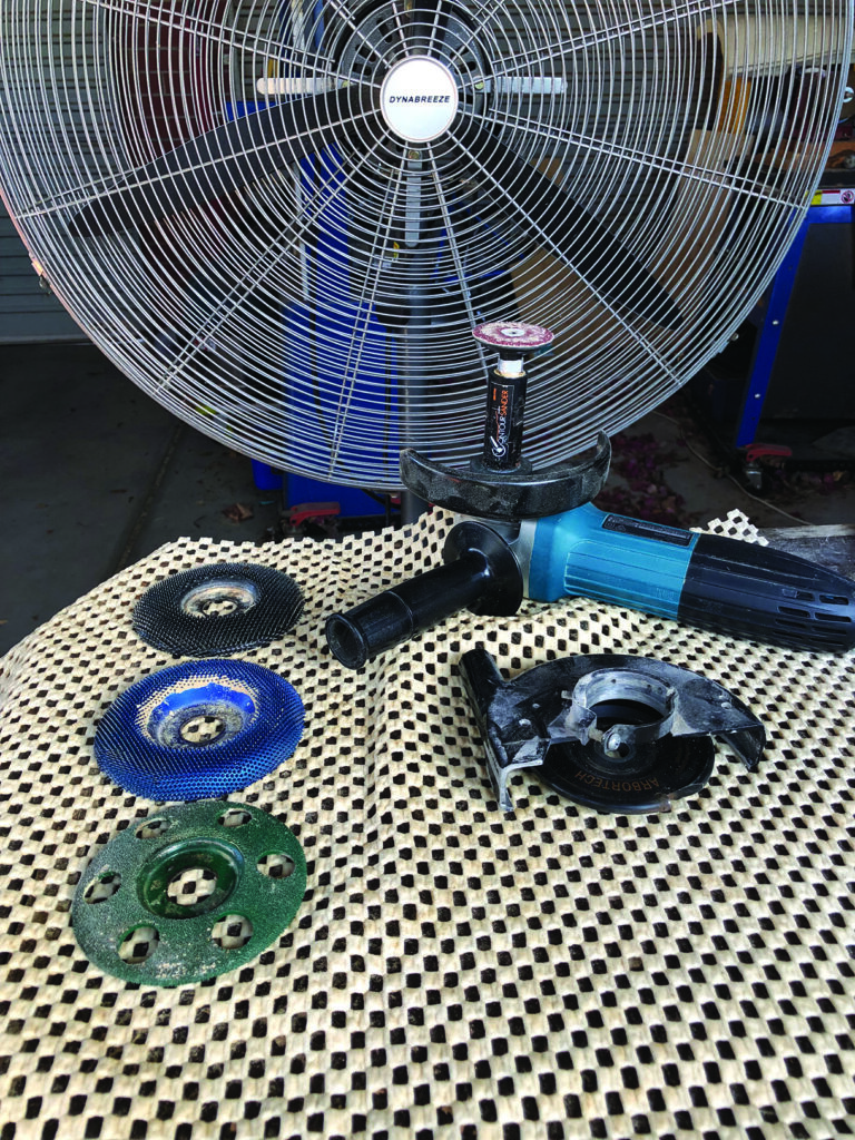 Grinding tool with various discs on table.