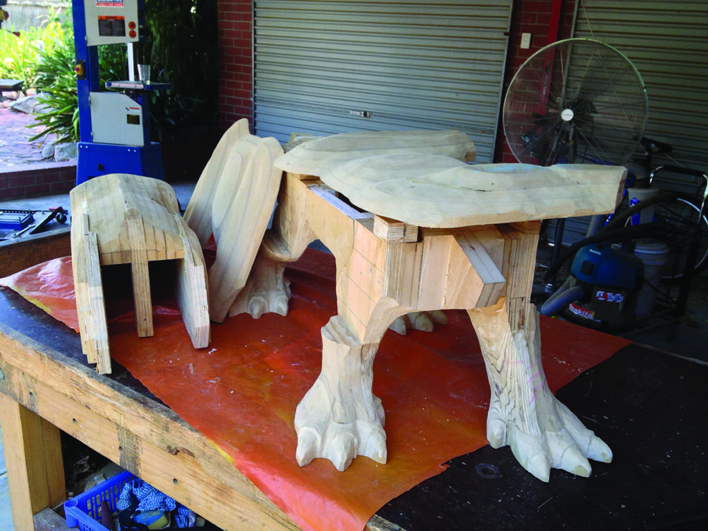 Wooden animal sculpture in workshop under construction.