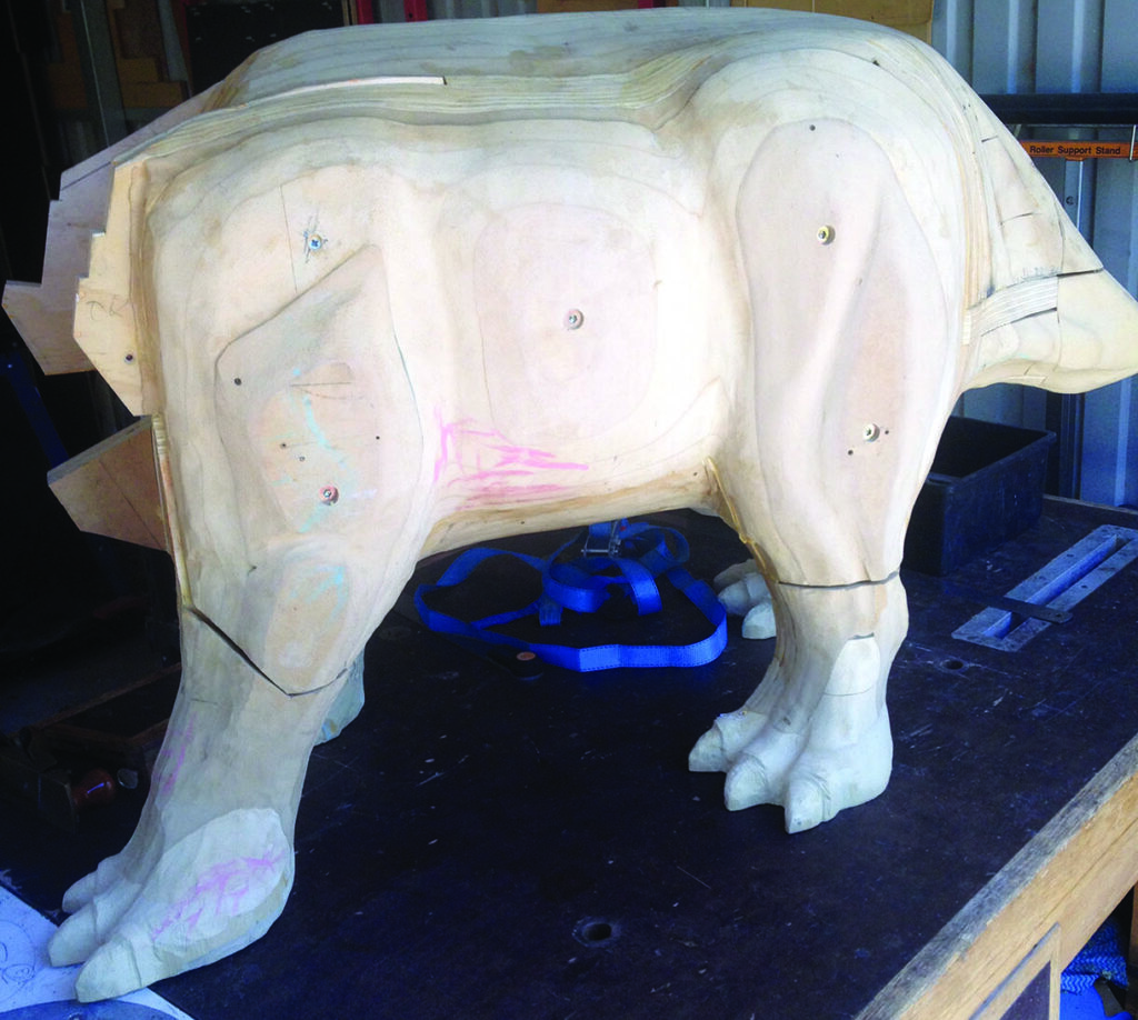 Wooden animal sculpture on workshop table