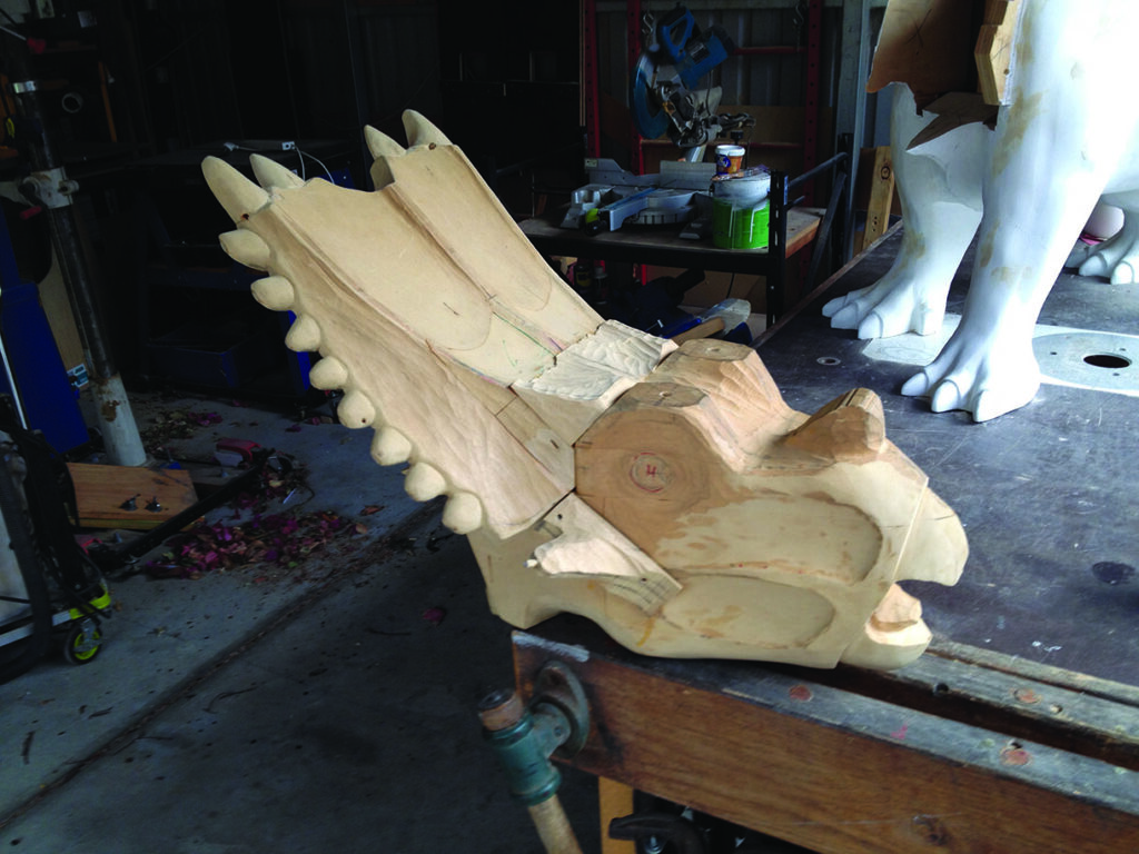 Wooden dinosaur sculpture in workshop