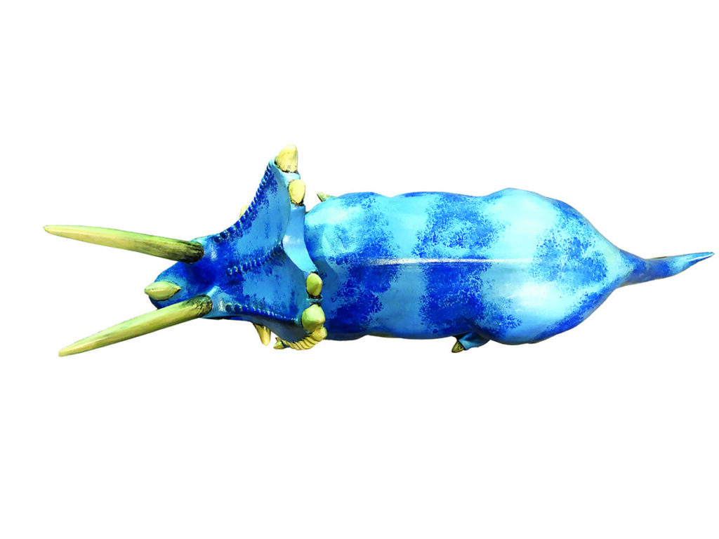 Blue triceratops dinosaur figure view from above.