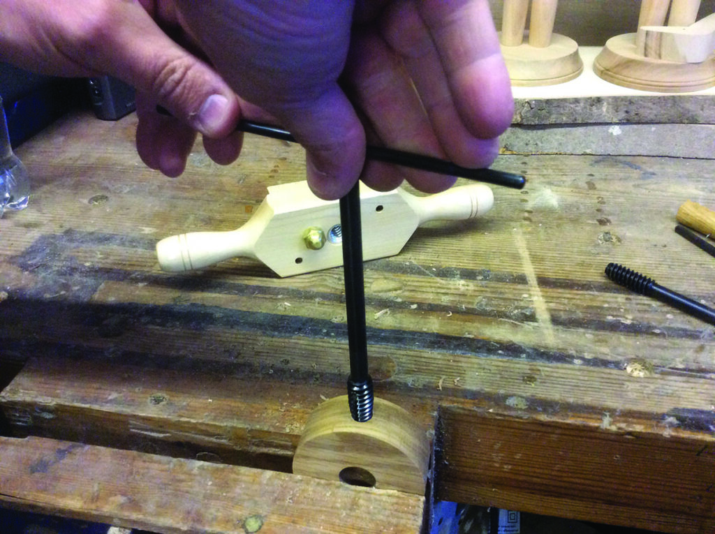 Hand threading a screw on wooden tool