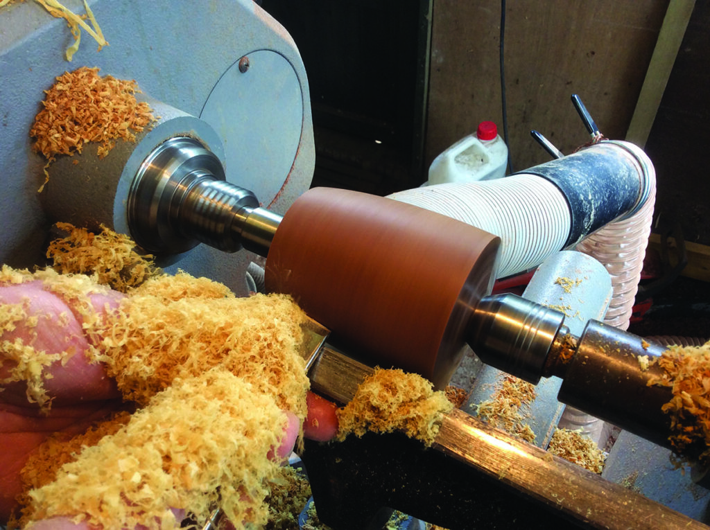 Woodturning process creating wood shavings