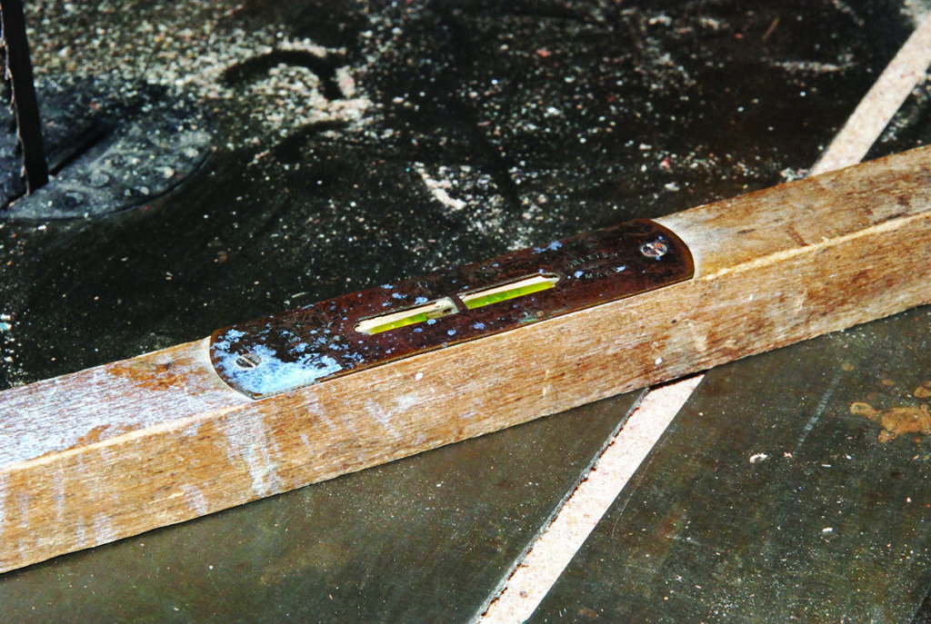 Wooden spirit level on concrete surface