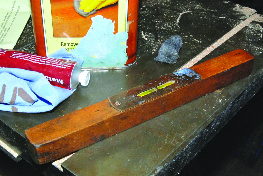 Workbench with spirit level, cloth, and metal polish