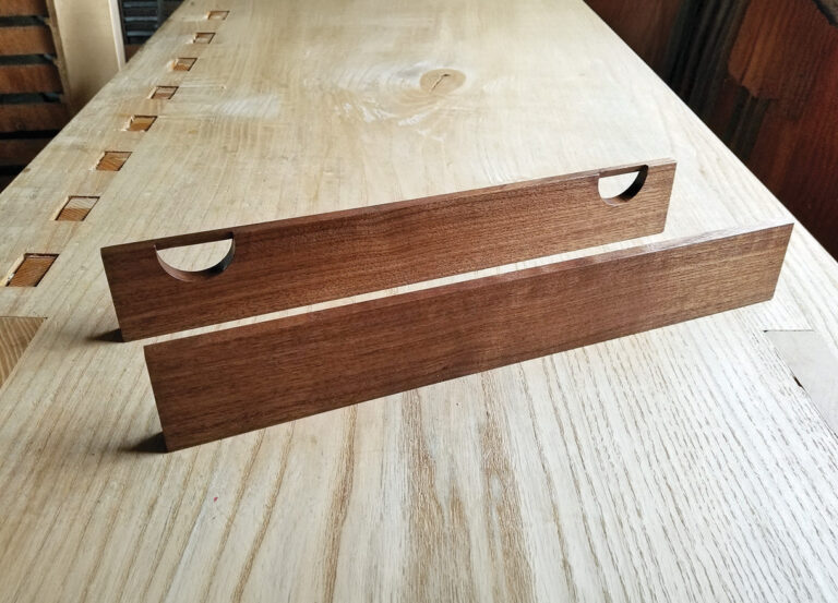 Wooden straightedges with notches on table surface.
