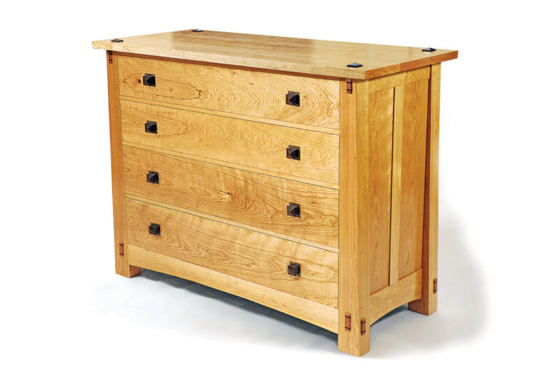 Wooden chest of drawers with four compartments.