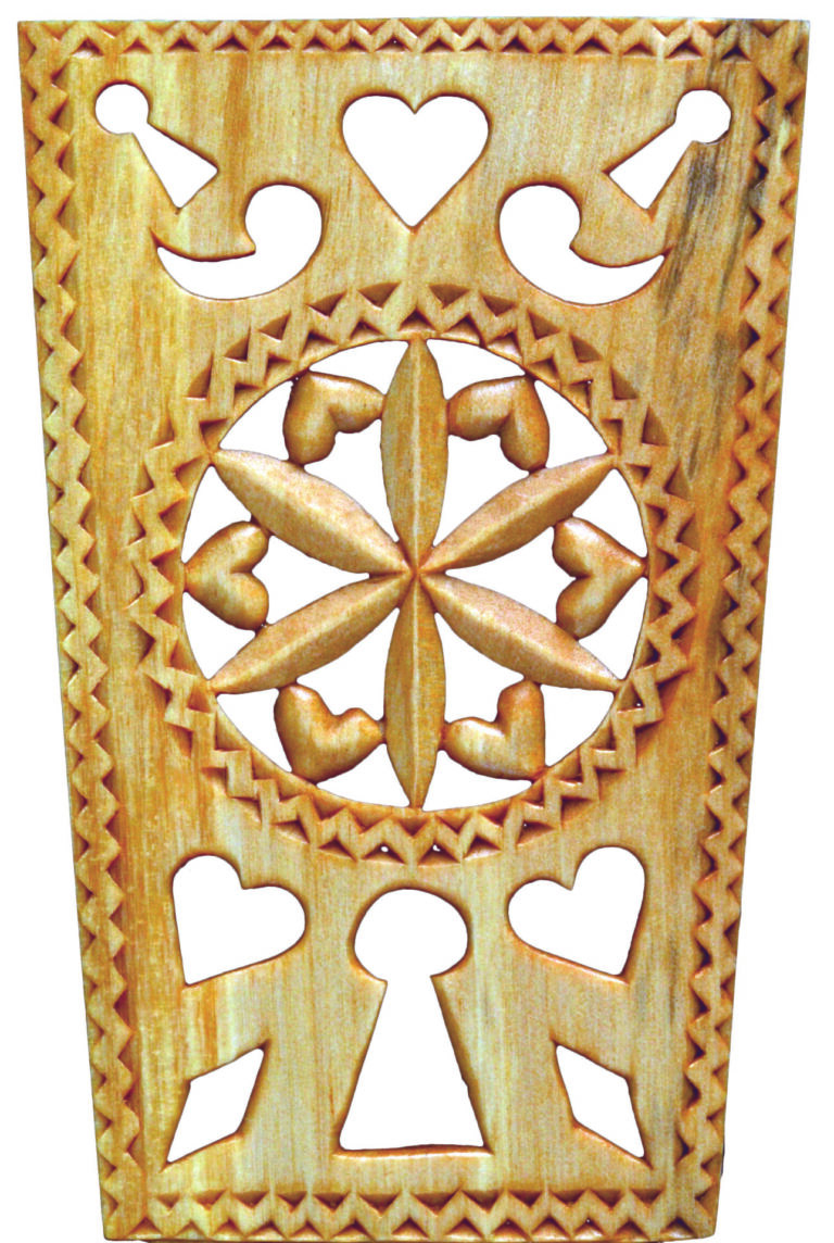 Ornate wooden carving with hearts and keyholes