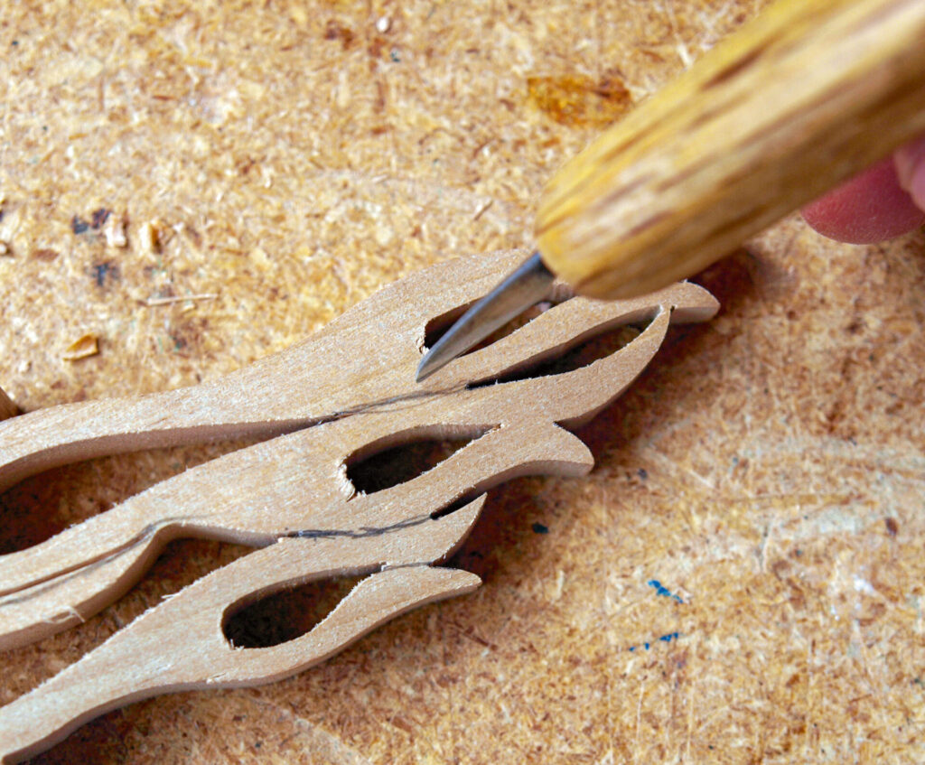 Wood carving design with detailed toolwork close-up.