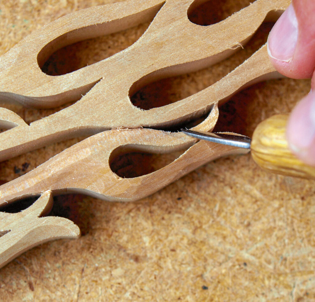 Intricate wood carving with hand tool detail.