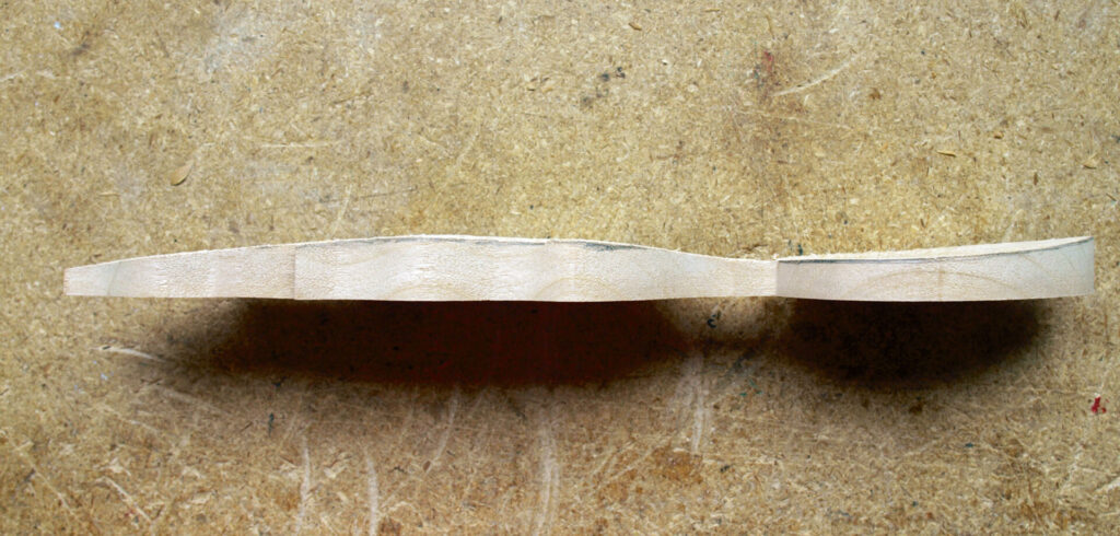 Unfinished wooden spoon on a textured surface
