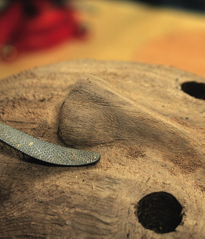 Wooden mask carving with chisel tool