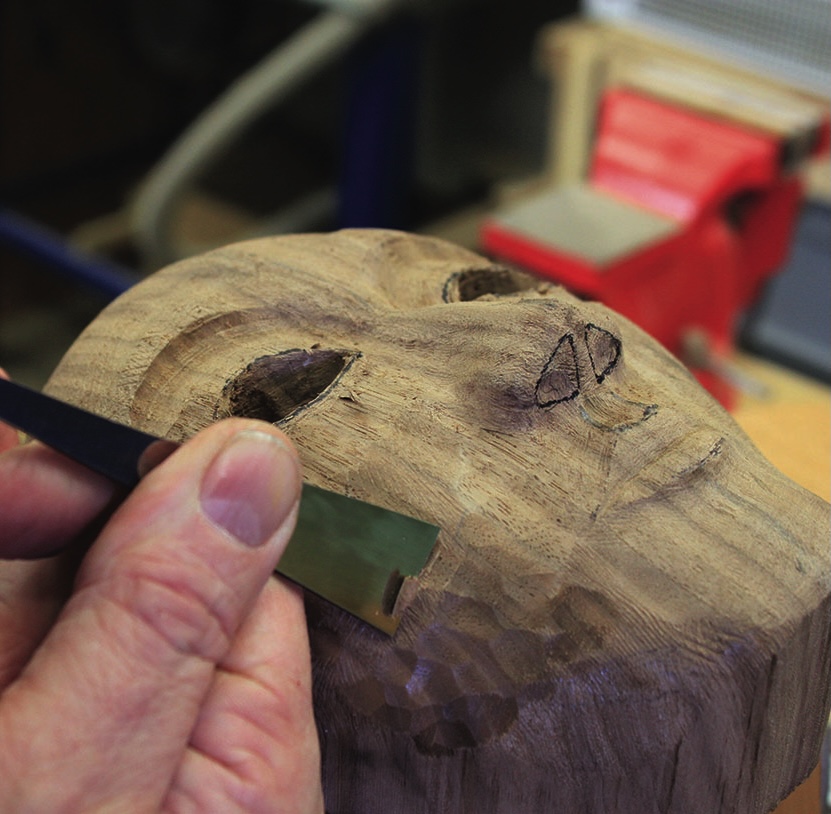 Hand carving wood mask with chisel